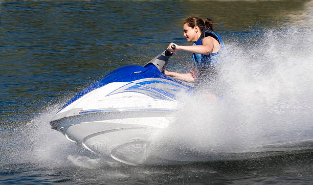 Action Photo of Young Woman on Seadoo Watercraft with Water-Spray stock photo