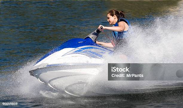 Action Photo Of Young Woman On Seadoo Watercraft With Waterspray Stock Photo - Download Image Now