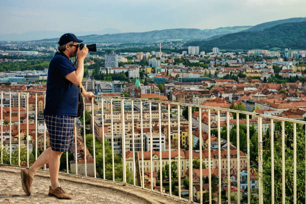 istock Man with camera taking photos of cityscape Maribor 966499098
