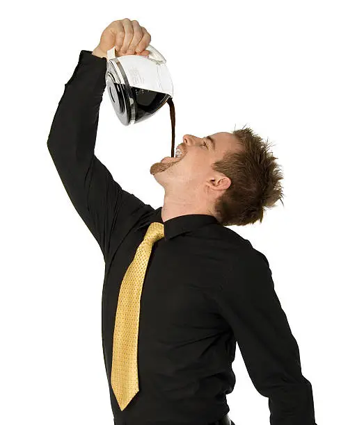 young businessman pouring coffee down his throat