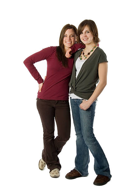 Full Length Photo of Two Teenage Girls Standing on White stock photo