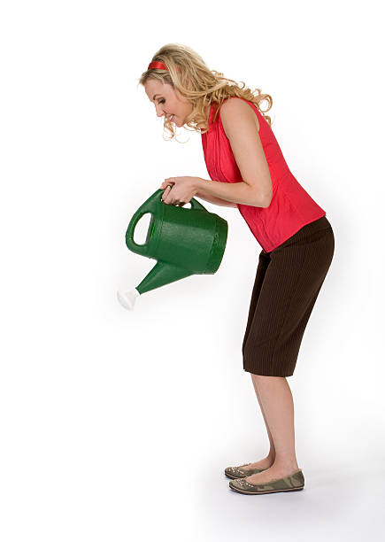 Woman Holding Watering Can stock photo