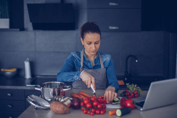 istock Woman preparing food in the kitchen 966506570