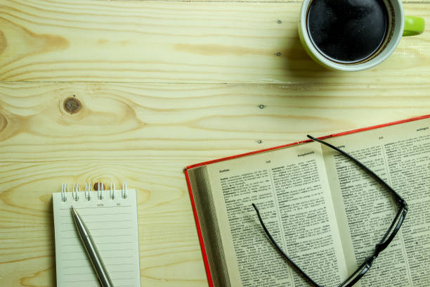 istock Work Table Setting Background with An Open Book and a Cup of Coffee 966508618