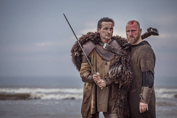 istock Two sword wielding bloody medieval warriors together on a cold seashore 966513092