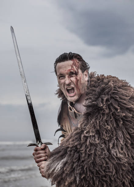 istock A screaming Weapon wielding bloody medieval warrior alone on a cold seashore 966513120