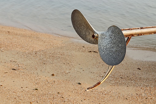 A close up shot of a longtail boat propeller. These boats transport thousands of tourists around each day in Koh Samui, Thailand.