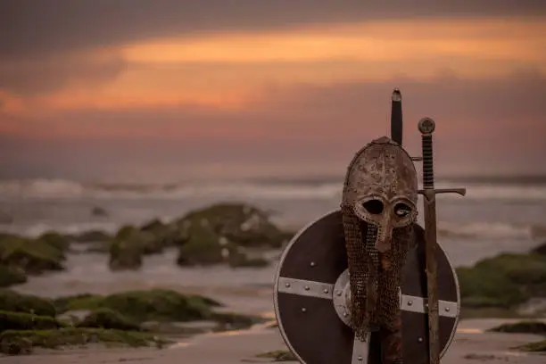 Medieval warrior equipment on a cold seashore at dusk