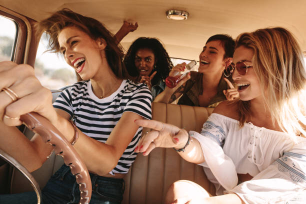 istock Friends traveling in car and having fun 966517028