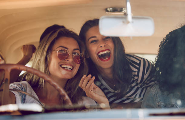 istock Friends going on vacation in a car and having fun 966517076