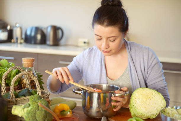 istock woman cooking in the kitchen 966524250