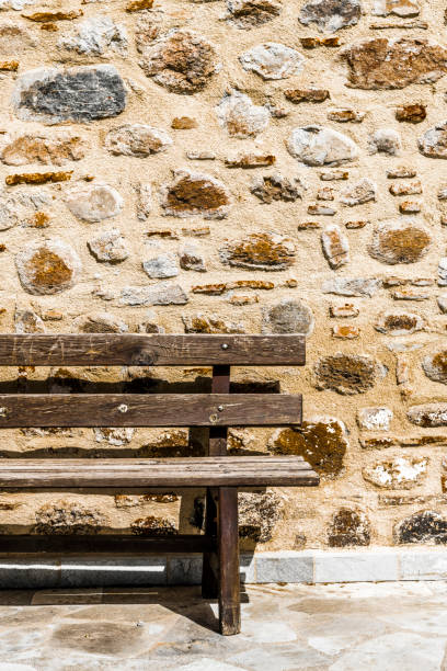istock Wooden bench at the ancient wall 966526984