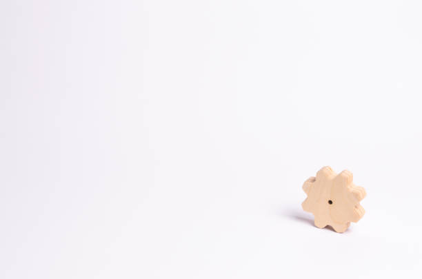 istock Wooden gear on a white background. Abstract background for presentations and banners. The concept of technology and industry, the think process. Part of a large complex mechanism. 966527608