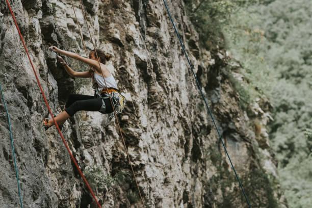 istock Focused young female climber, climbing up alone 966527902