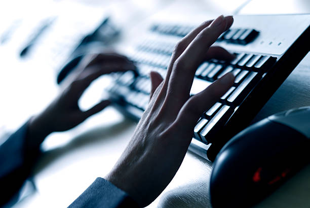 istock Blurred hands typing on a keyboard in a dimly lit room 96653220