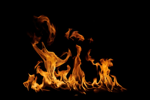 Fire burning on a black background. Ideal for compositing with another image. The background can be removed with a blending mode like screen.