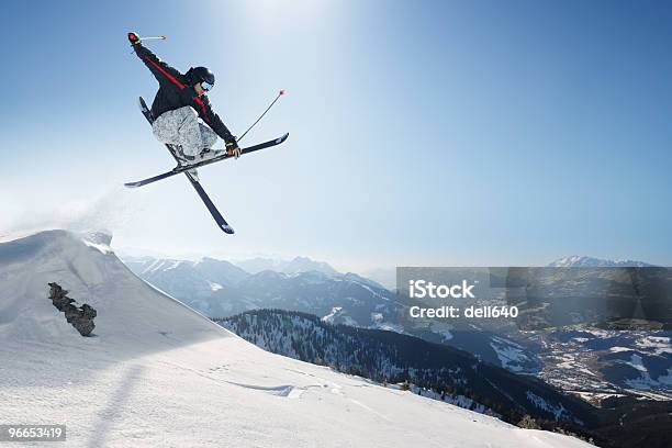 Jumping Skier On A Snowy Mountain Stock Photo - Download Image Now - Skiing, Ski, Jumping