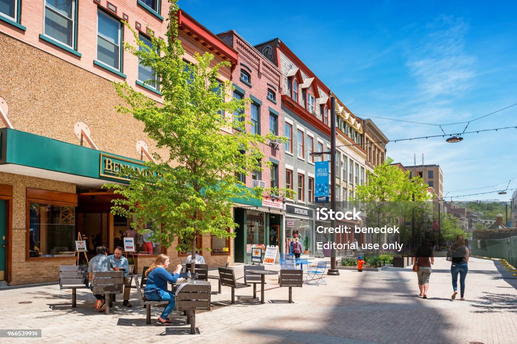 Downtown Ithaca New York State USA People have lunch and walk in a pedestrian area of downtown Ithaca, New York State, USA on a sunny day. Ithaca Stock Photo
