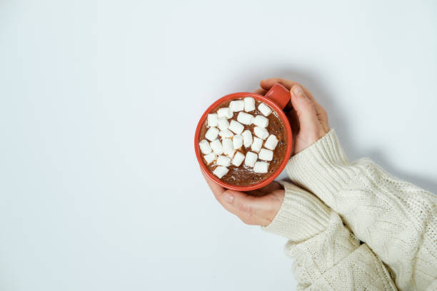 istock Female hands with cocoa with marshmallow on white background. Space for text 966552150