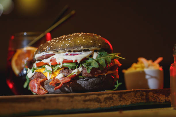 istock Tasty beef burger on wooden table 966552174