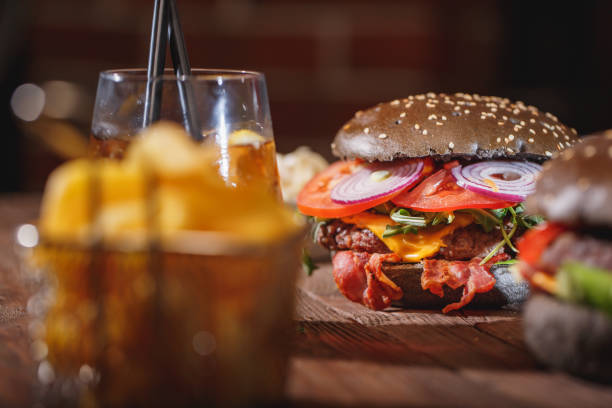 istock Tasty burger on wooden table 966552404