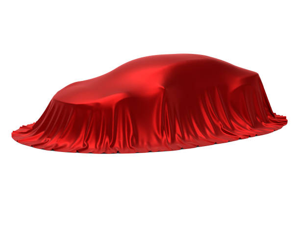 istock New car presentation, model reveal, hidden under red cover, isolated on white background 966554700