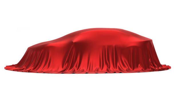 istock New car presentation, model reveal, hidden under red cover, isolated on white background 966554762