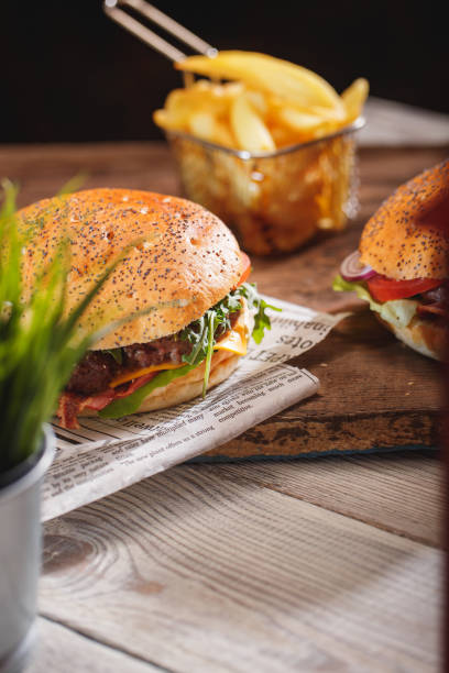 istock Tasty burger on wooden table 966554958
