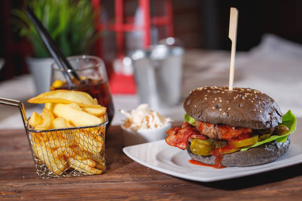 istock Tasty burger on wooden table 966555152