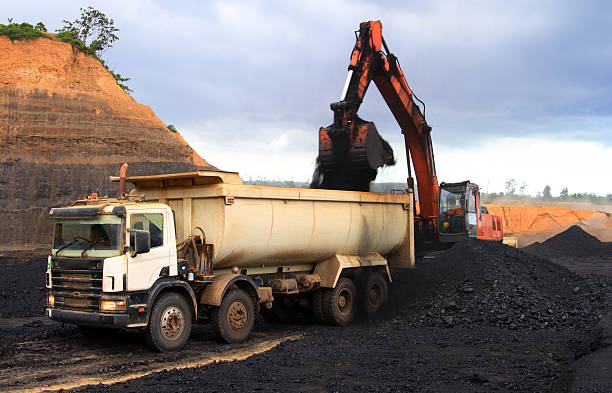 A coal truck being filled with coal Mining truck hard at work. construction truck bulldozer wheel stock pictures, royalty-free photos & images