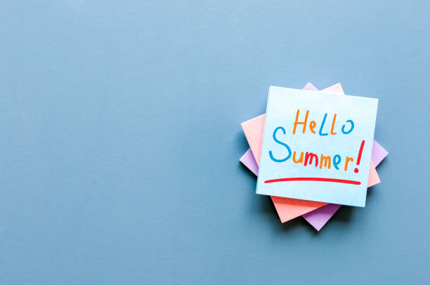istock Hello Summer - inscription at notes on blue office background. First summer day, Calendar concept. With copy space for text 966558532