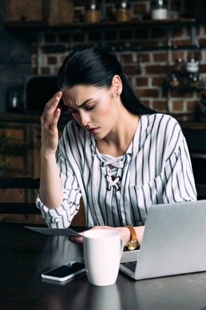 istock young sad woman sitting on kitchen and looking at photo 966564276