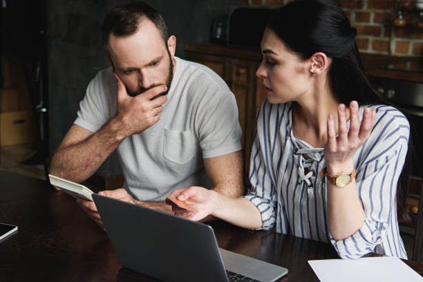 istock stressed young couple with laptop and calculator counting credit dept 966566812