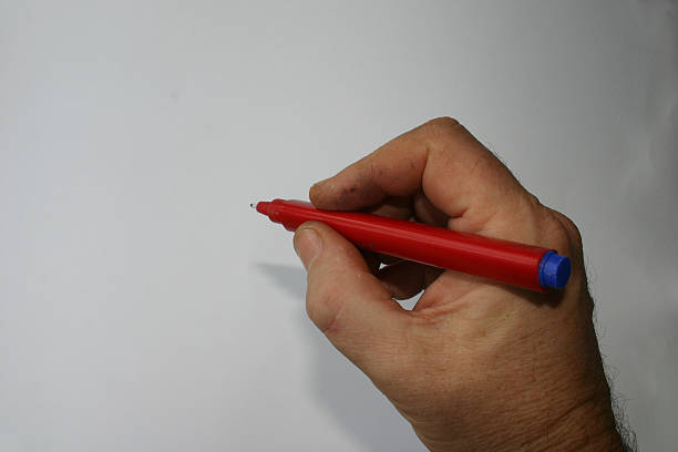 istock Man's hand with red pen 96657380