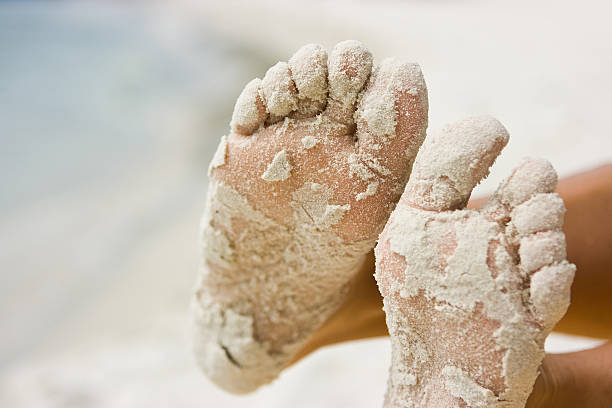 istock Female feet in sand 96657829