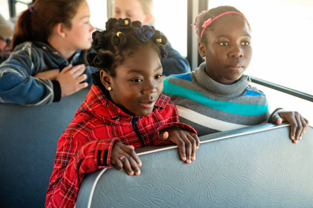 istock Group of multi-ethnic kids sitting on school bus. 966578294