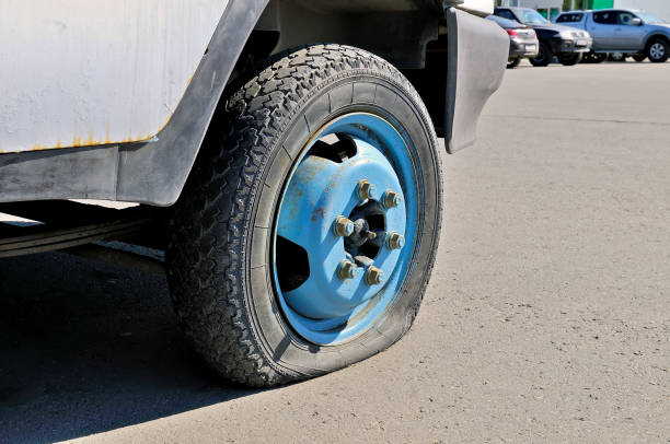 istock Flat tire of an old rusty cargo car 966578658