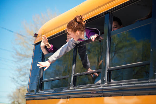 istock Girls saying goodbye on school bus. 966580458