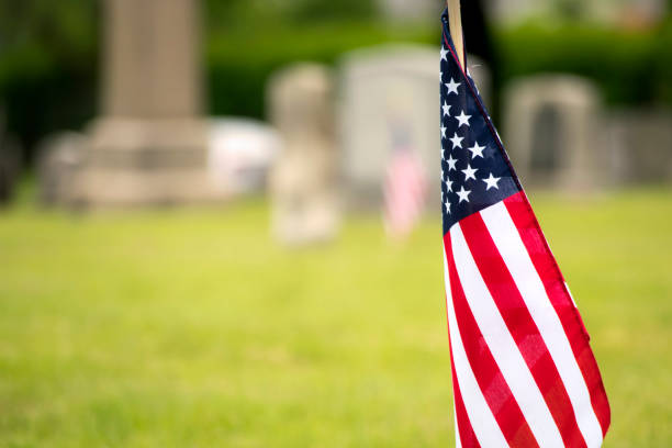 istock American Flag in the Foreground in the Cemetary 966587404