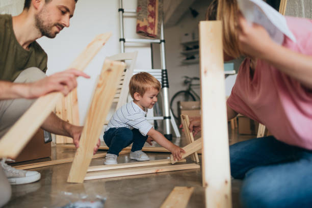 istock Young family assembling furniture together 966587410