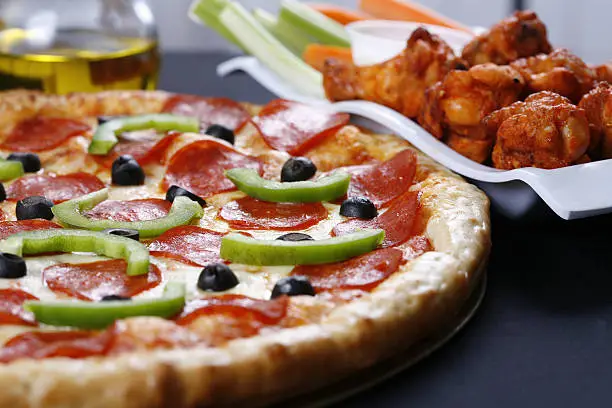 Photo of pizza and wings