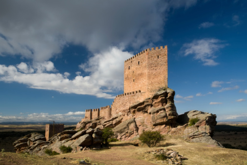 Wall of castle ruins, stone wall texture . \nMedieval castle ruins, old European architecture, ruined window of an old castle made of stone