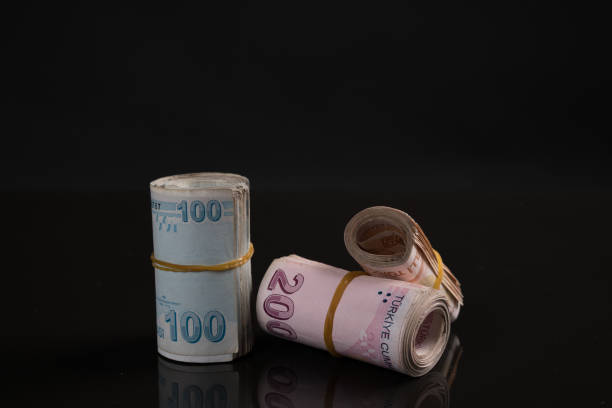 Bundled Turkish Lira Bundled Turkish Lira over black background turkish lira photos stock pictures, royalty-free photos & images