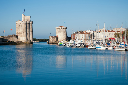La Rochelle, in Nouvelle Aquitaine, France - July 25, 2010. It's marina entrance, with a great tower named Saint Nicolas Tower, in La Rochelle.