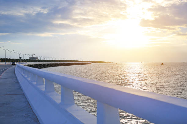 istock Cement bridge on sea and beautiful sky sunset. 966659706