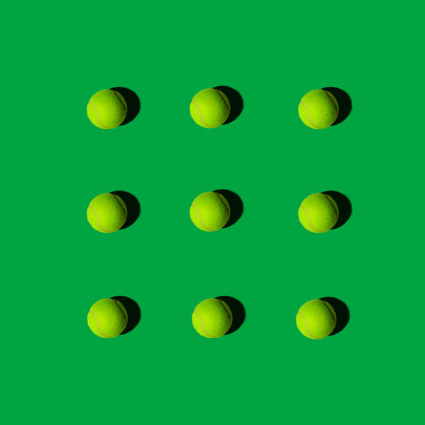 istock Tennis Balls in Pattern on a Green Background, Flat Layout 966664346