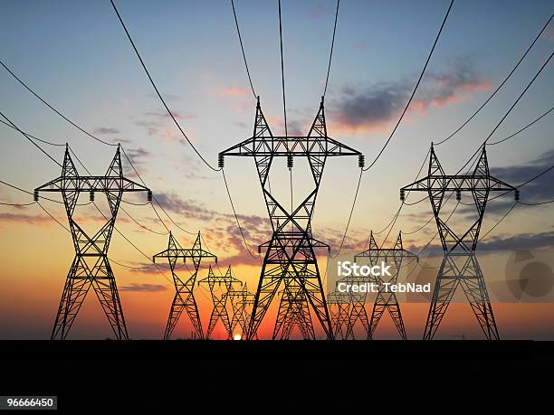 Rows Of Electric Power Lines At Sunrise Stock Photo - Download Image Now - Back Lit, Backgrounds, Built Structure