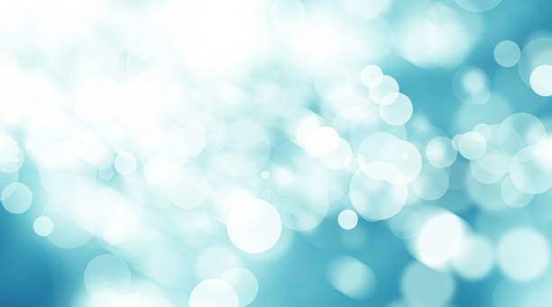 istock white circle on blue blur abstract background. bokeh christmas blurred beautiful shiny Christmas lights 966684320