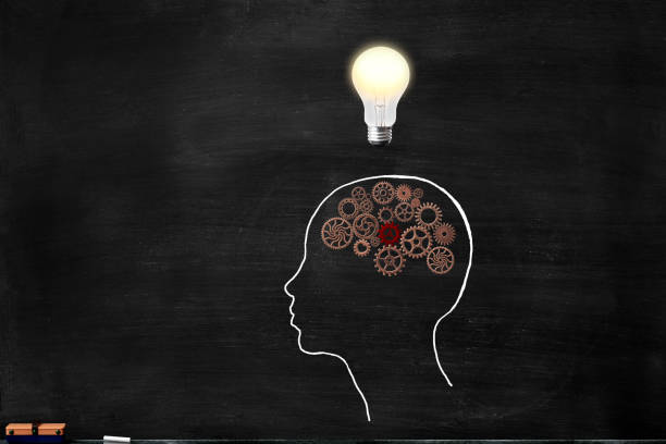istock Illuminated light bulb and human head with metal gears drawn on the blackboard 966686890