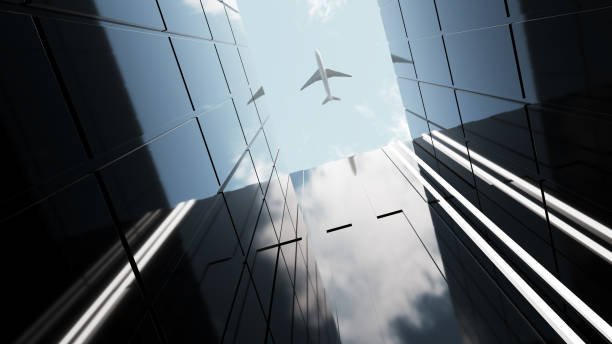 istock Plane flying over generic modern glass and concrete office buildings 966689480